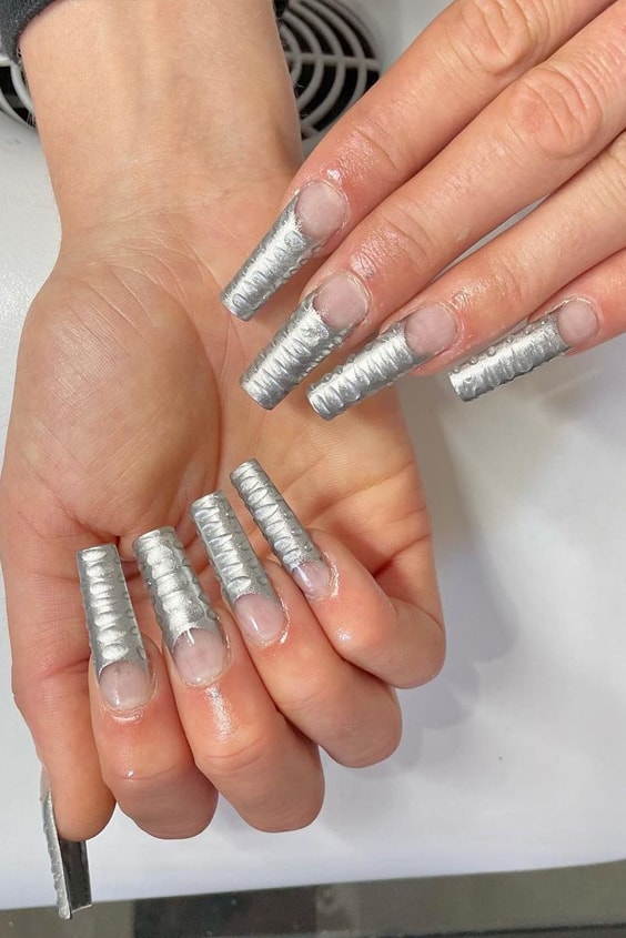 The post is about the 21 awesome ways to wear chrome nails this season. It features nails that are shaped into different shapes, sizes and colors. There are some beautiful photos in the post that show some of the designs. Read this post for some inspiration on how to spice up your nail game! #chromenails #chromenailart #chromenaildesigns #chromeacrylicnails