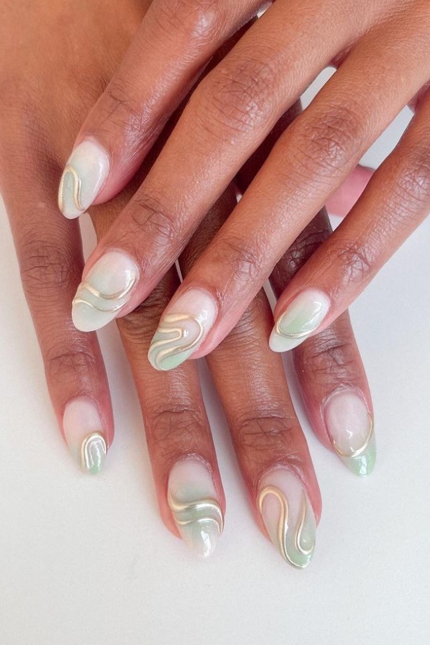 Close-up photo of sleek almond-shaped nails with a minimalist design, featuring a neutral color palette and clean lines