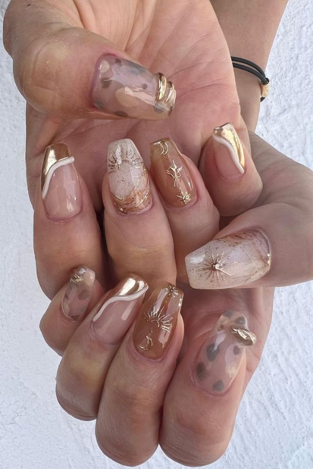 Embrace the celestial allure with these gold sun and moon nail inspirations. Adding a touch of heavenly glow to your fingertips!