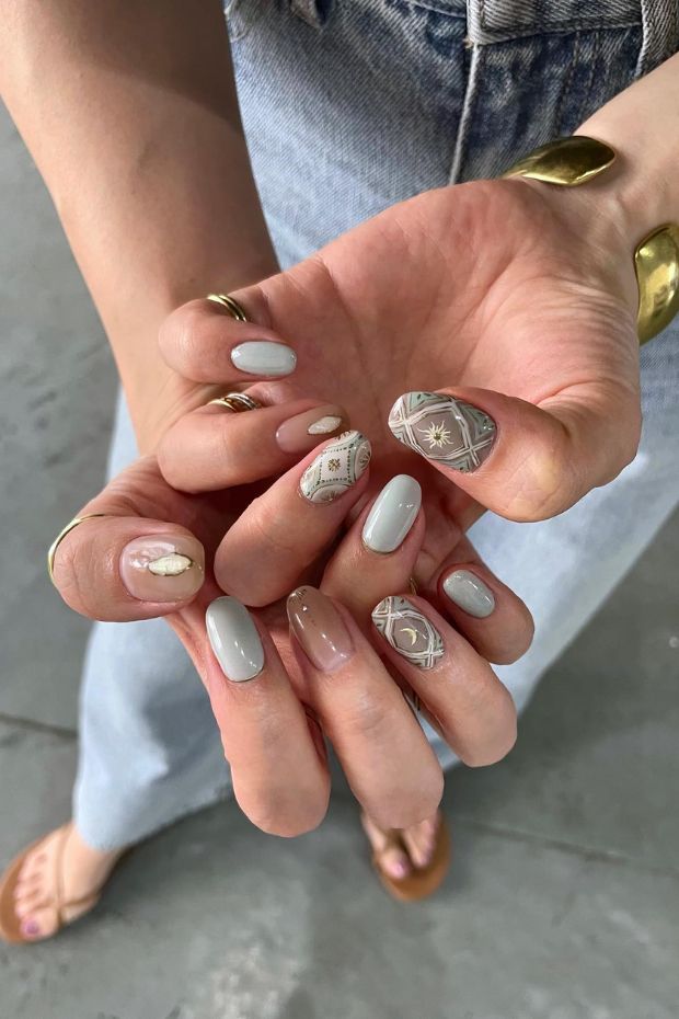 Embracing celestial elegance with these stunning golden sun and moon nail art. Nailing the cosmic vibes!