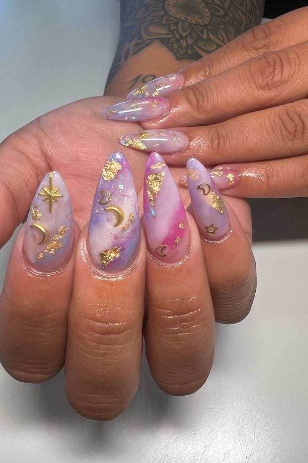 Channeling celestial vibes with these stunning gold sun and moon nail inspirations.