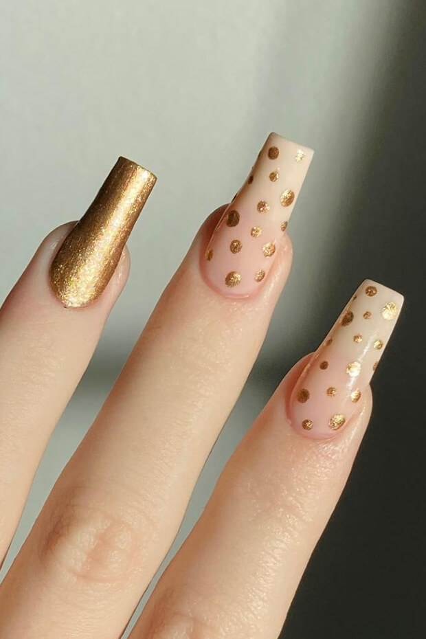 Gold polka dots on pink background nail art design
