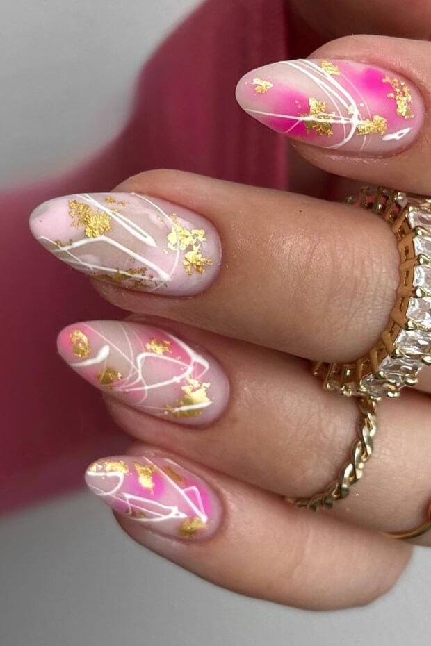 Pink and gold luxury nail art with intricate leaf patterns
