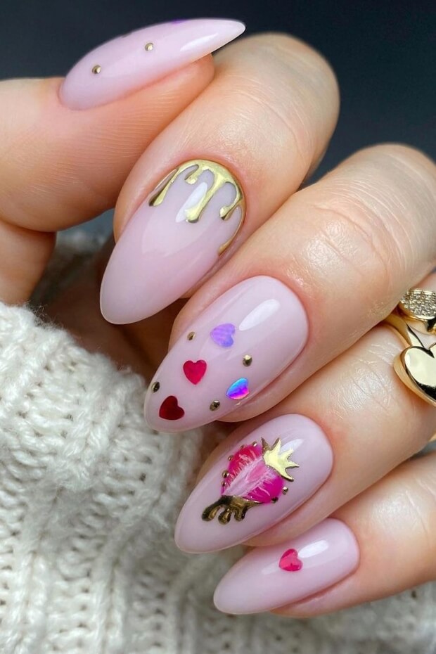 Pink almond nail with gold crown and heart
