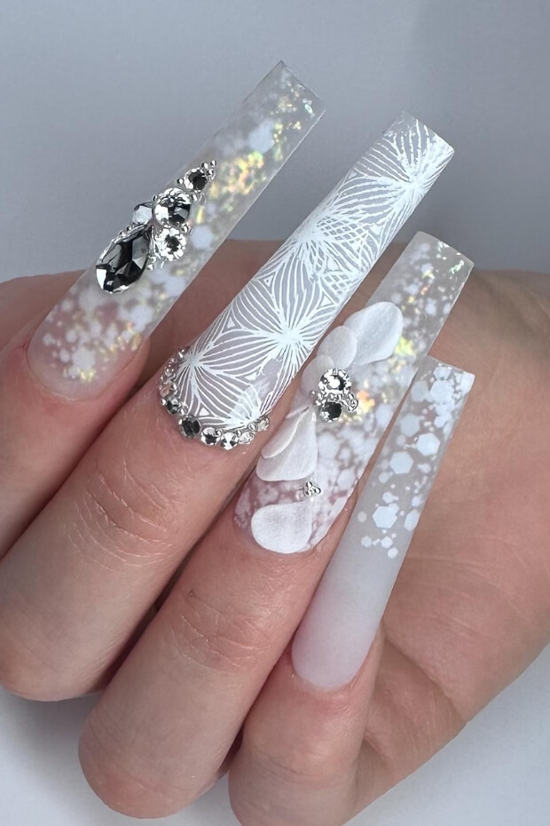 White flower, silver butterfly, and black diamond nail art