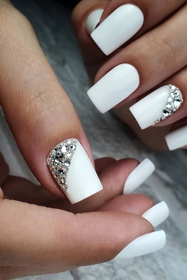 White nail art with diamond accent