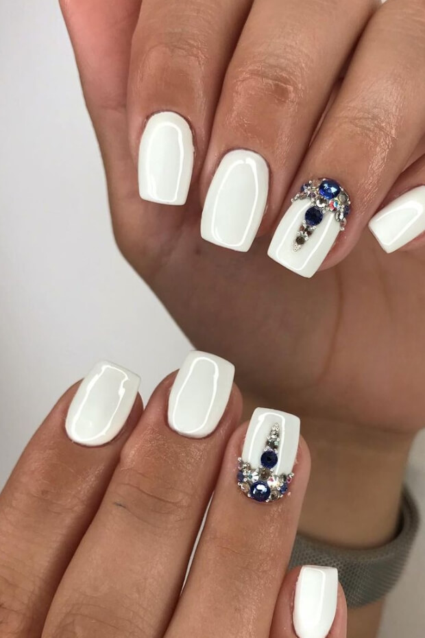 White nail art with rhinestones