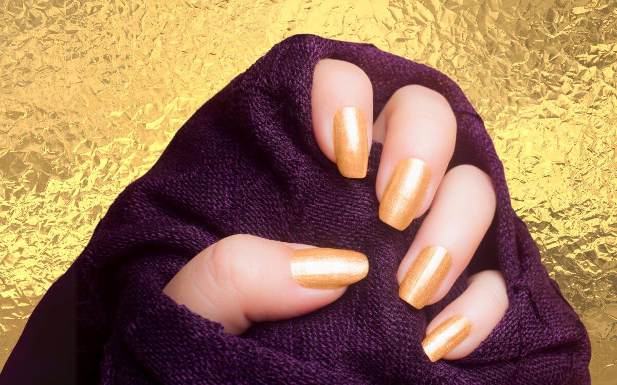 Check out our collection of 25 classy and elegant gold nail designs! From subtle glitter accents to intricate patterns, these ideas will add a touch of glamour to any occasion. #goldnails #glitternails #elegantnails #nailartinspiration