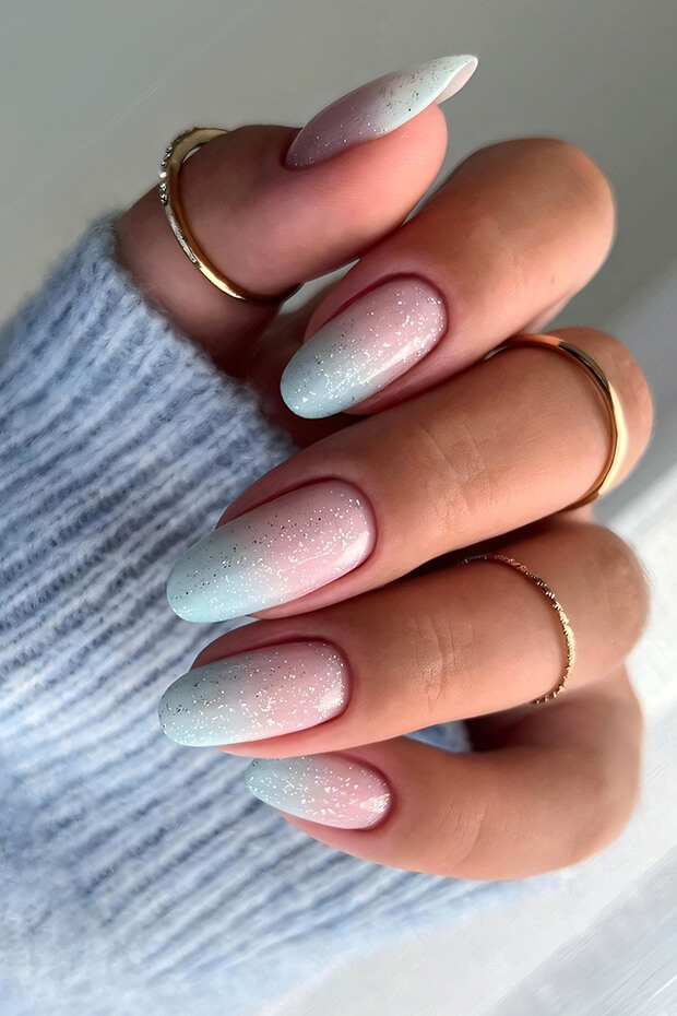 Almond nail design with light blue and pink gradient