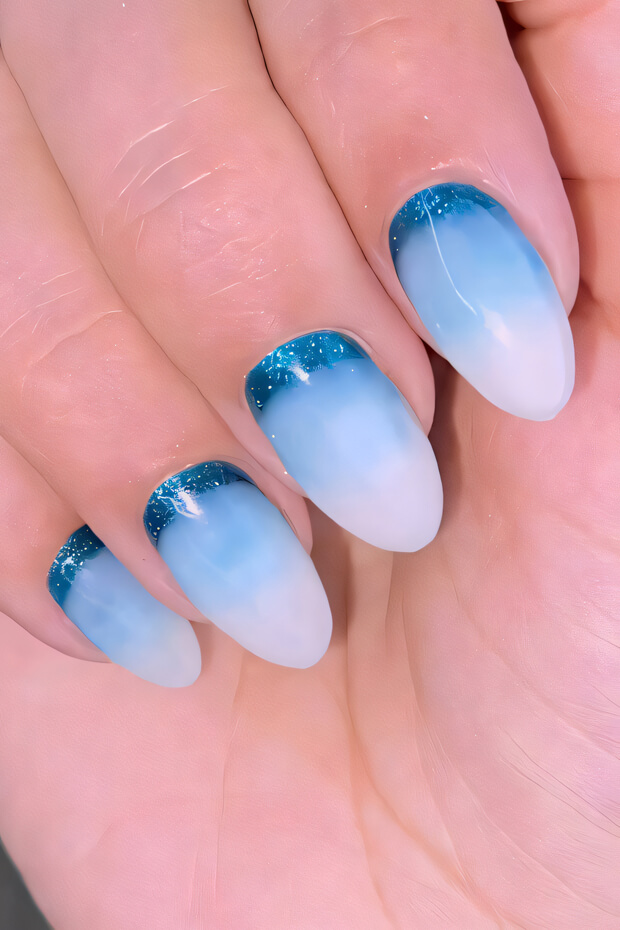 Blue and white gradient nail art with shimmer