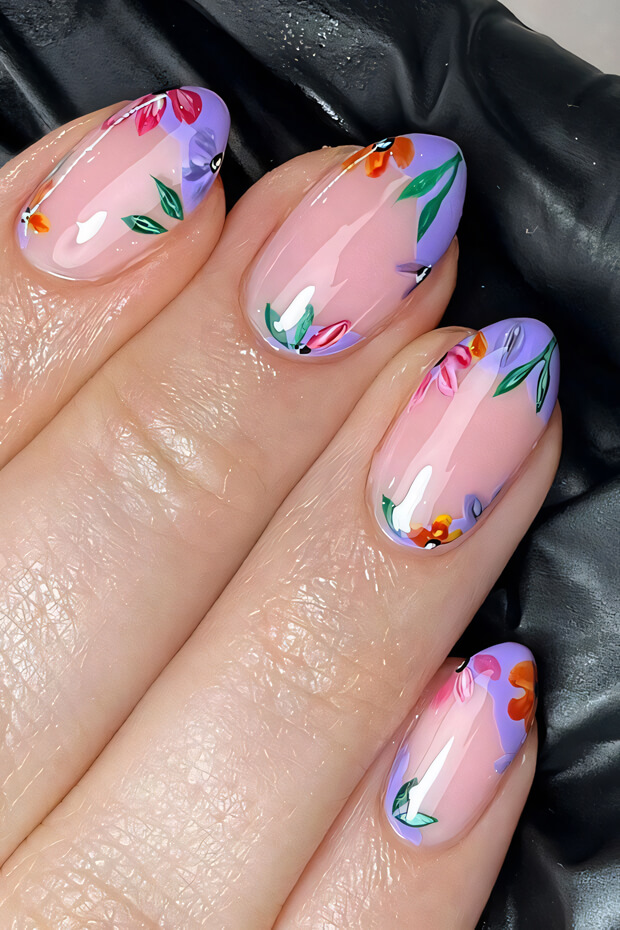 Colorful floral design on a pink nail with vibrant flowers and leaves