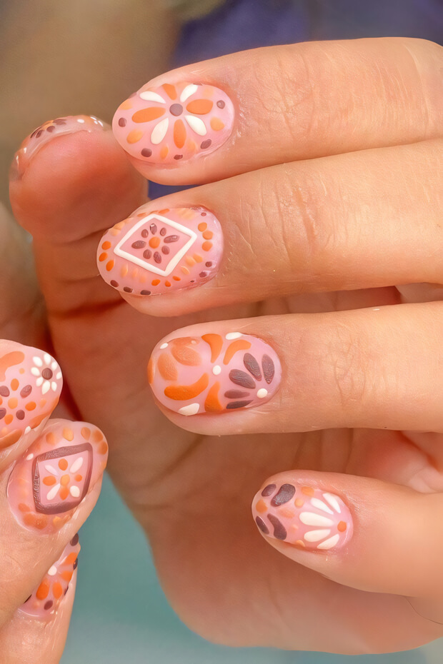 Intricate and colorful nail designs with various floral patterns