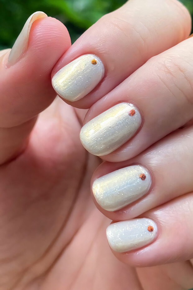 Creamy White Nails with Shimmering Gold Dots