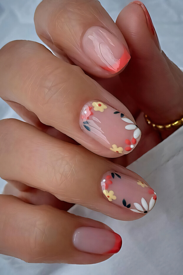 Nail art with pink, white, and orange flowers and leaves on the edge