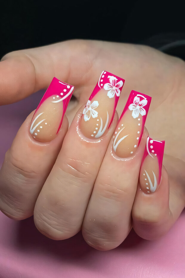 Pink and white French manicure with hibiscus flowers and dots