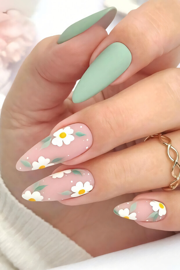 Pastel green nails with white daisies and green leaves in intricate pattern