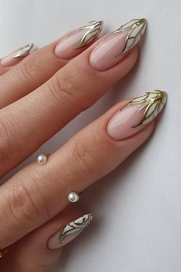 Intricate gold leaf pattern nail art design