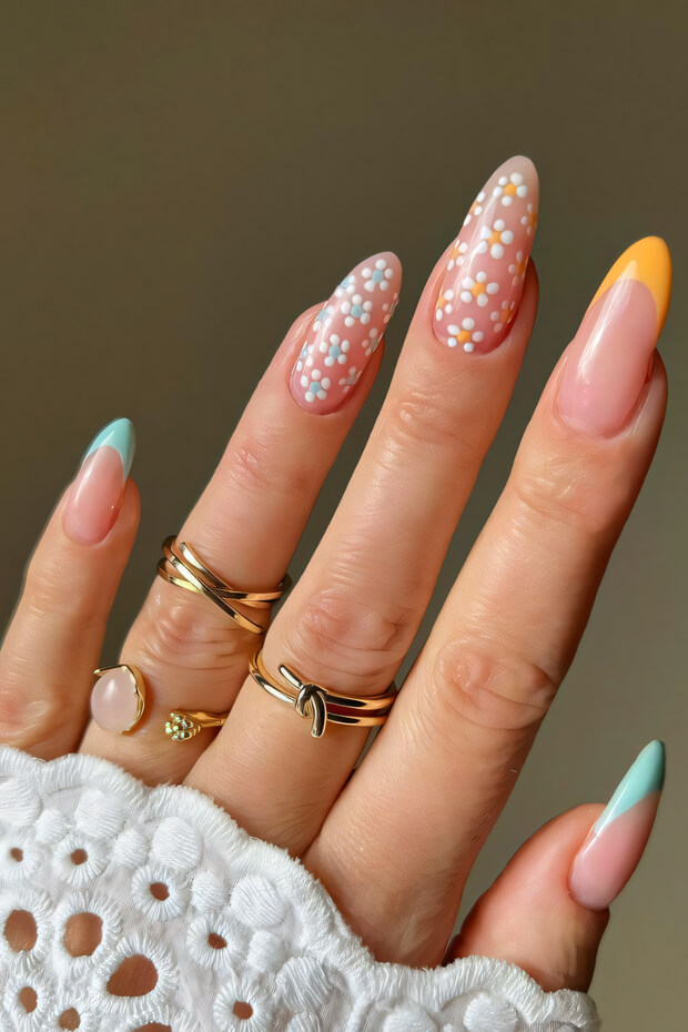 Manicure with pastel colors, white polka dots resembling daisies