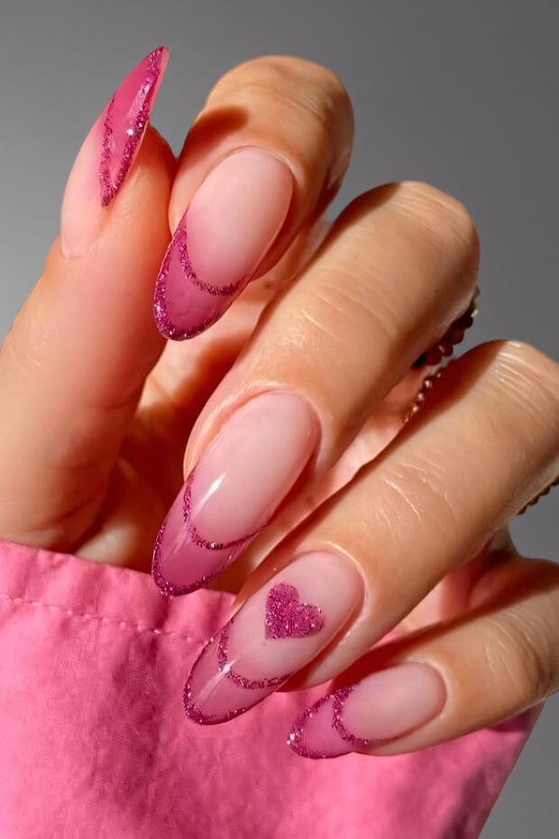 Pink nail with heart-shaped glitter accent
