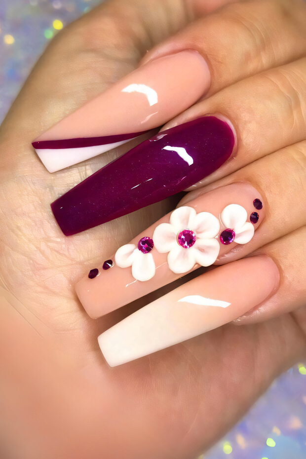 Purple and white nails adorned with delicate flowers