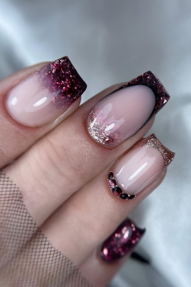 Pink and purple ombre nail art with glitter accents
