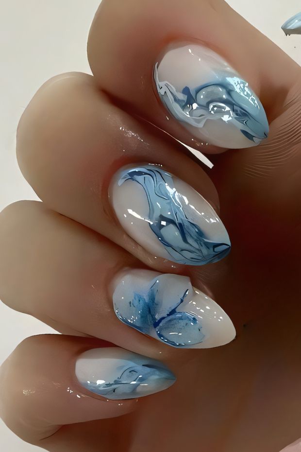 Elegant blue and white swirl nail designs perfect for chic nail art lovers and trendsetters.