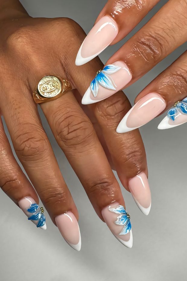 Nail art featuring floral designs on French tips for a chic and elegant appearance.