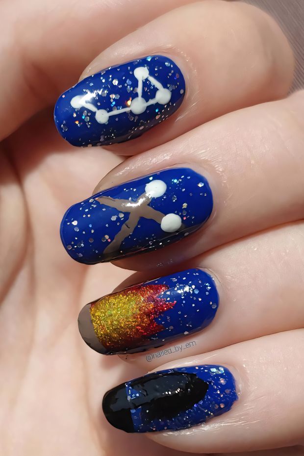 Camping nails featuring constellations, starry night sky, and vibrant campfire colors for outdoor enthusiasts.