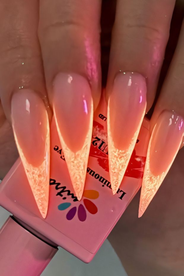 Ombre stiletto nails with textured tips in beautiful peach color for trendy nail art inspiration.