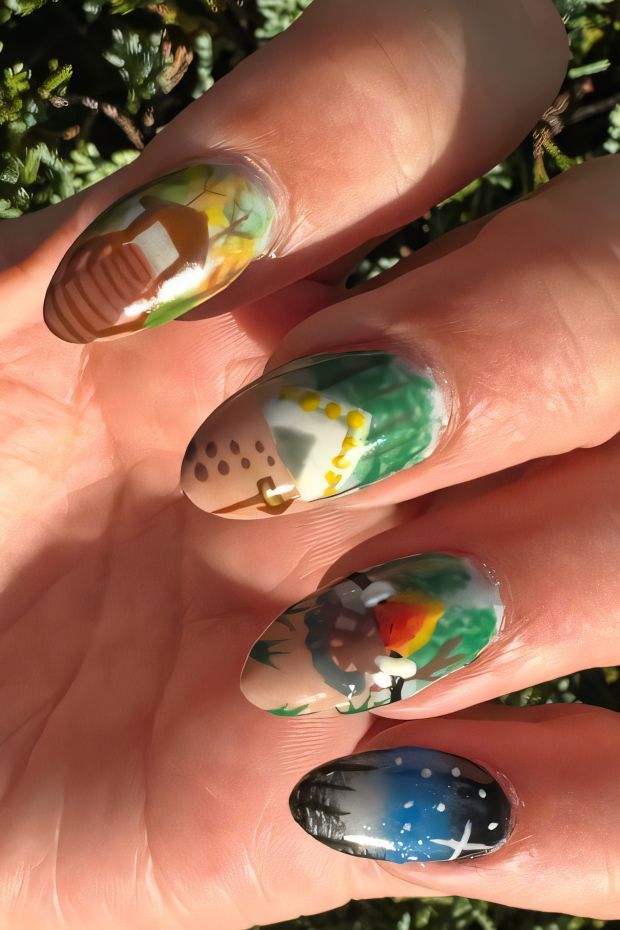 Camping themed nail art with tents, trees, stars, and earthy colors for a nature-inspired look.