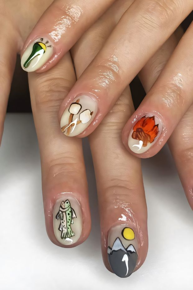 Camping-themed nail art with mountains, fish, and nature elements for outdoor enthusiasts.