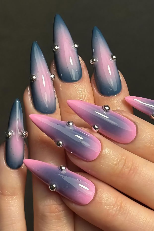 Chic ombre nail design in blue and pink with silver bead accents on stiletto shape.