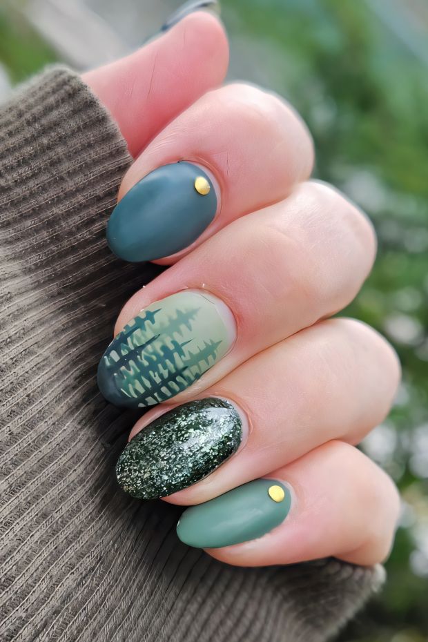 Camping nails with forest-inspired designs, featuring tree patterns and earthy colors, perfect for nature lovers.