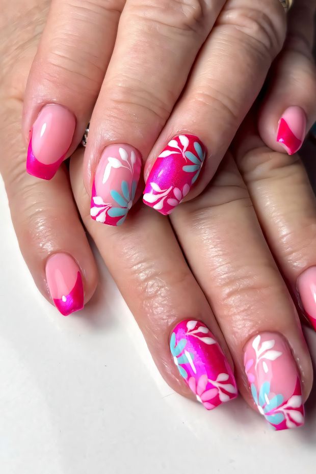 Colorful floral nail art with pink and blue accents, showcasing unique designs for vibrant nail fashion.