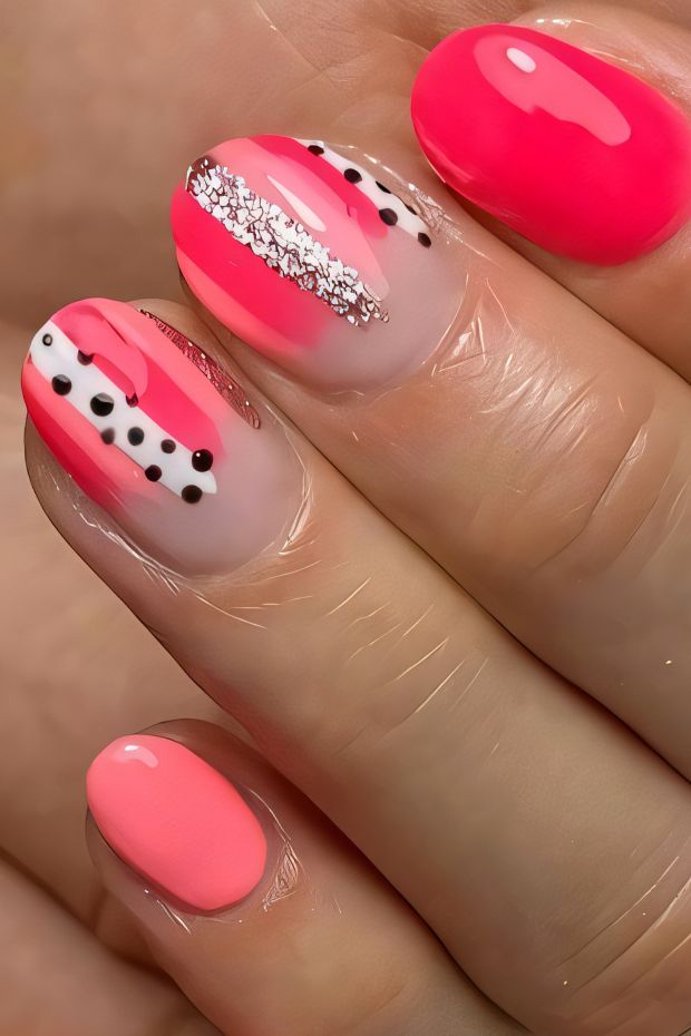 Vibrant polka dot nail design featuring pink shades and unique patterns, ideal for a trendy manicure.