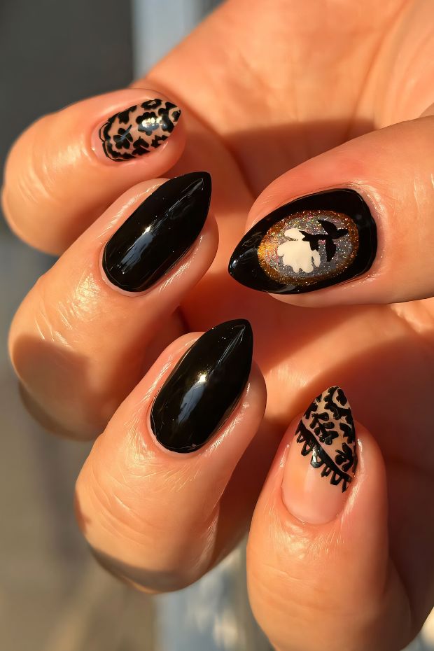 Black nail art featuring shapes, animal print designs, and creative accents for a stylish look.