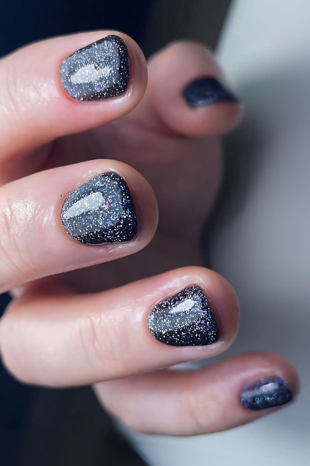 Black nails with glitter design showcasing a sparkling gradient effect for a chic look.