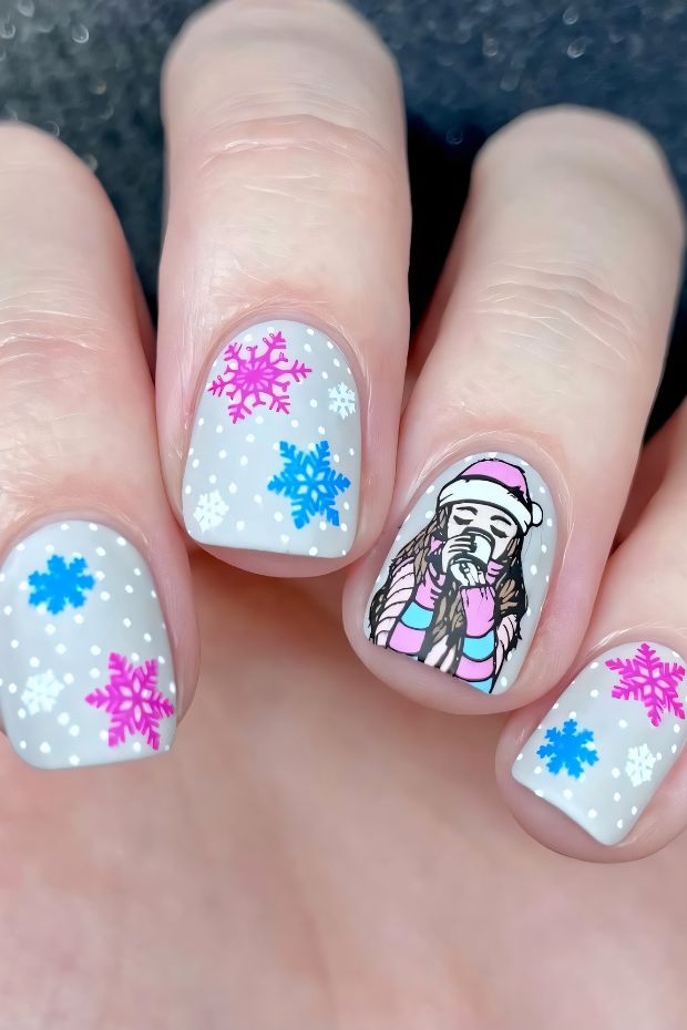 Winter nails design with colorful snowflakes and a character in cozy winter attire on a grey base.