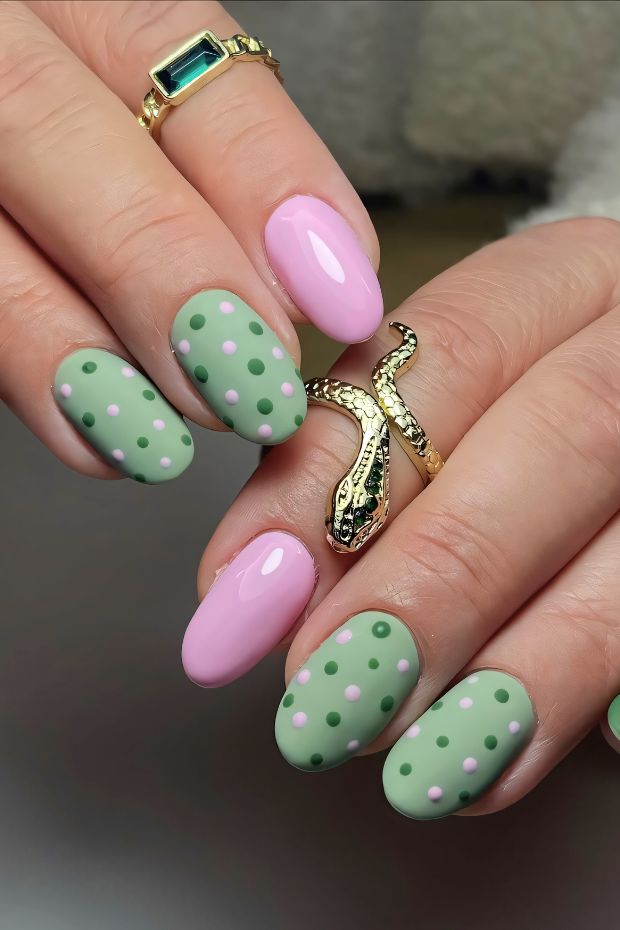 Vibrant green and pink polka dot nail art design with assorted dot patterns and accessories.
