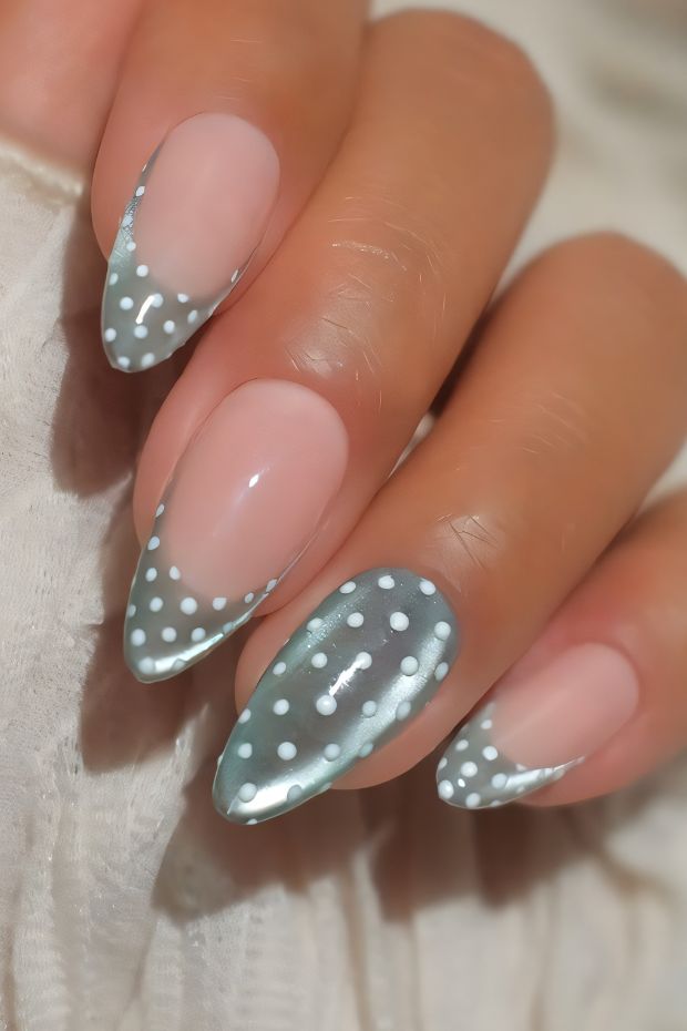 Elegant polka dot nail design featuring a neutral base with playful white dots and chic tapered tips.