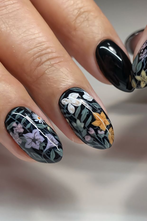 Black nails featuring floral designs in pastel colors with a sleek, modern look for nail art enthusiasts.