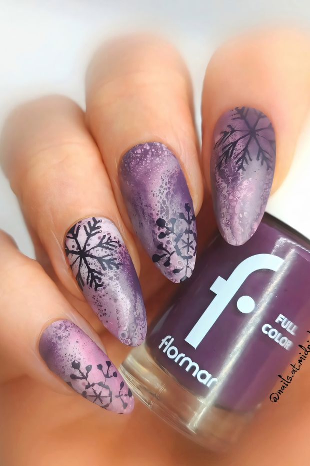 Winter nails design featuring purple ombre and intricate snowflake art for a seasonal look.