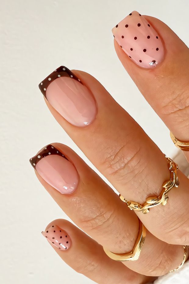 Trendy polka dot nail design with chocolate tips on a nude base