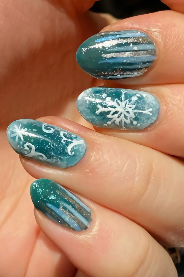 Winter nail art featuring snowflakes, blue gradients, and silver accents for a frosty festive look.