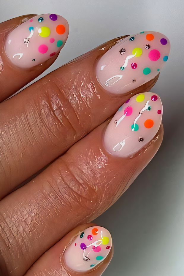 Vibrant polka dot nail design with colorful dots on a nude background for a cheerful appearance.