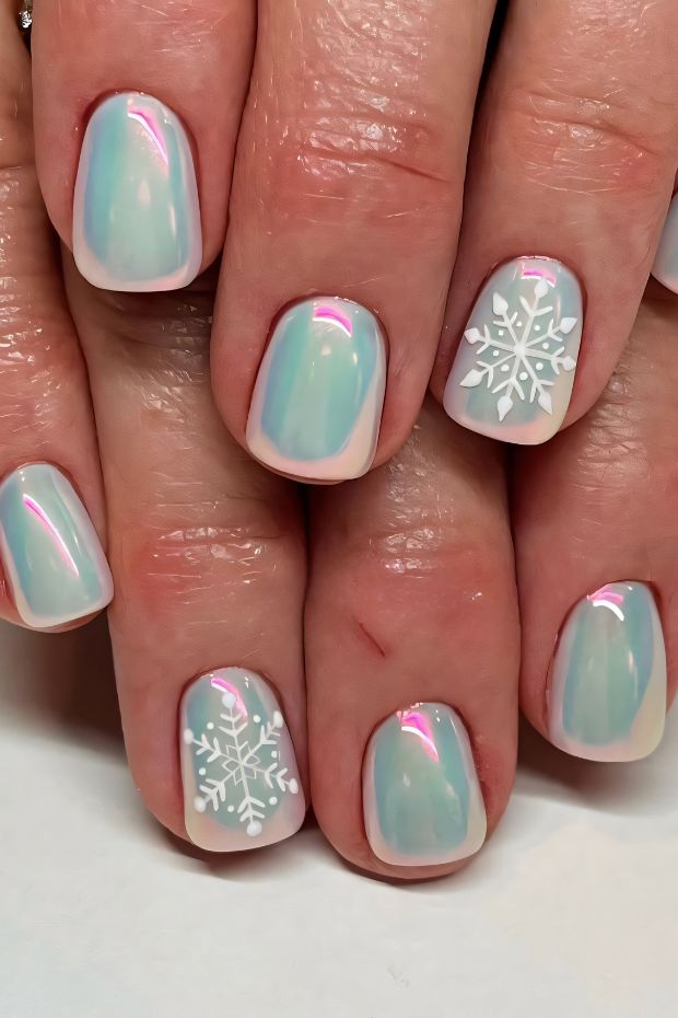 Winter nail art with pastel colors and white snowflake designs for a chic seasonal look.