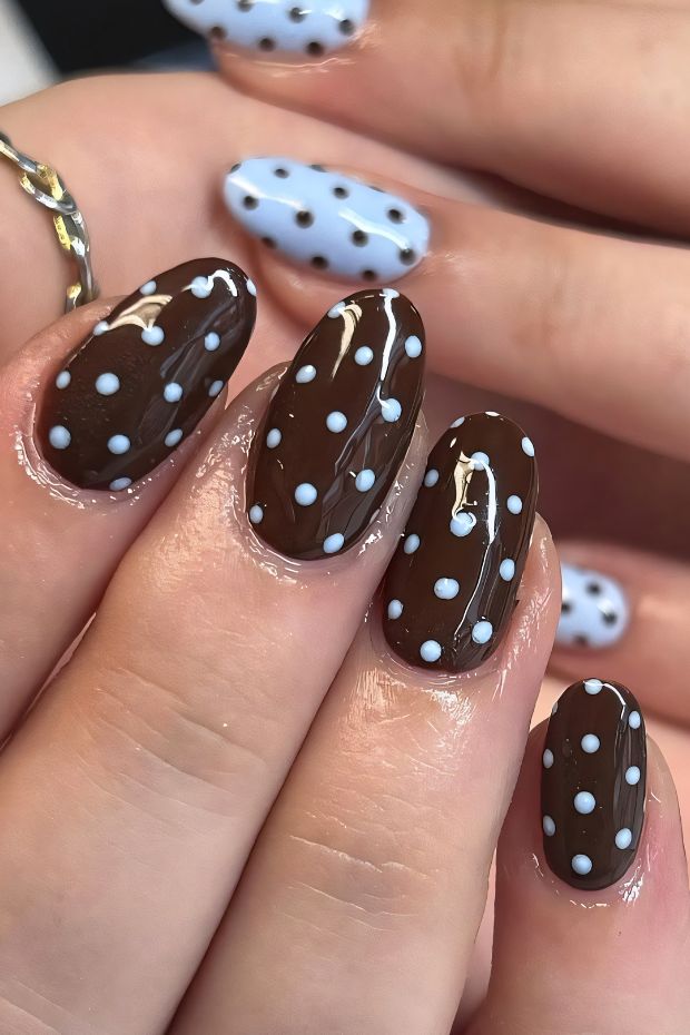 Brown nails with white polka dots for a fun nail art design.