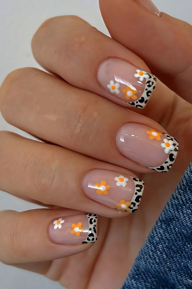 Chic short nails featuring floral designs with a leopard print tip and a nude base color.