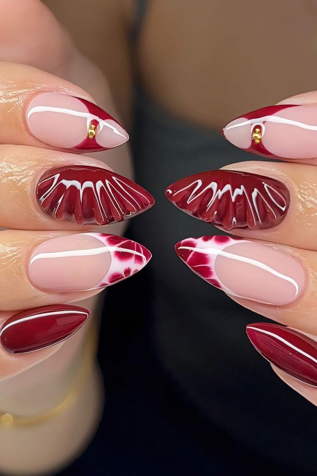 Elegant red nail design featuring unique patterns and glossy finishes, perfect for stylish nail art enthusiasts.