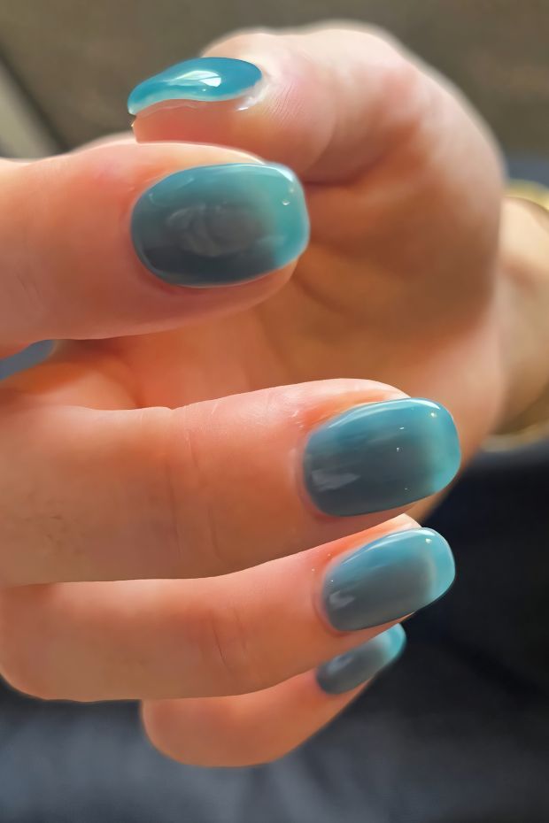 Ombre teal nail design featuring glossy finish with gradient effect from dark to light teal.